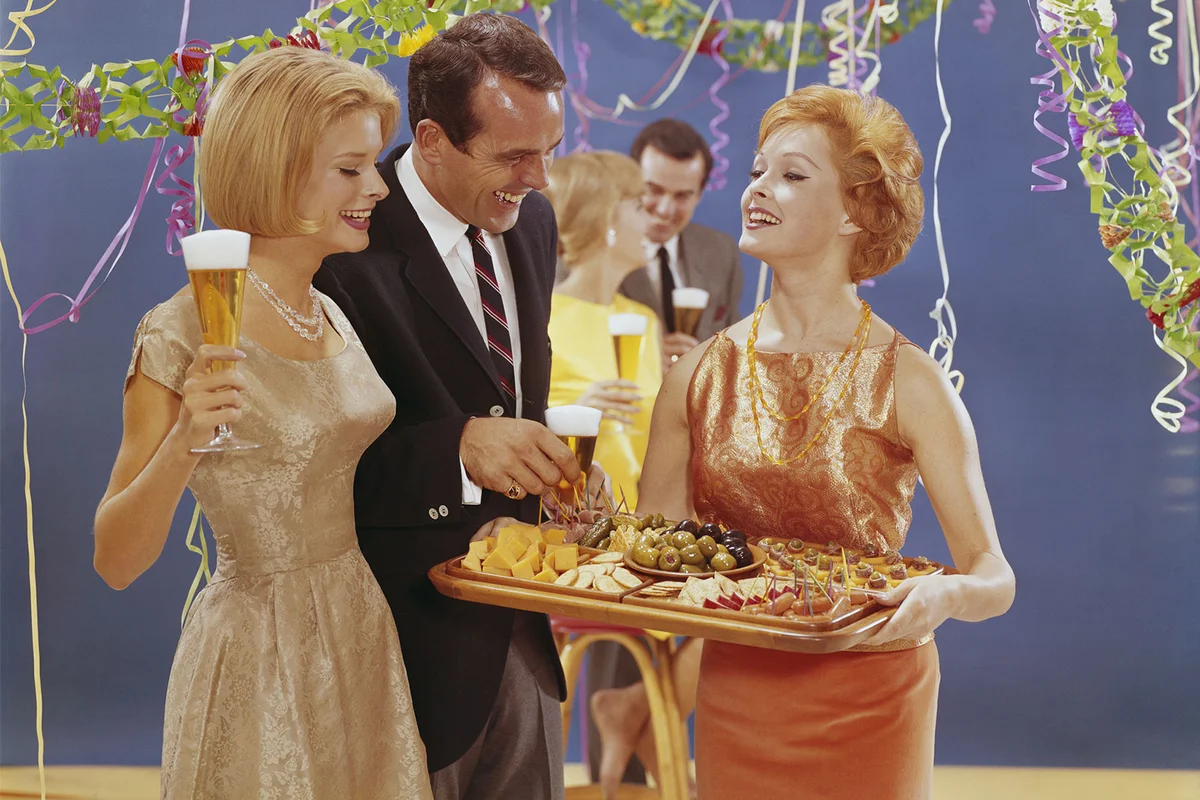 1950s Woman serving appetizers at party