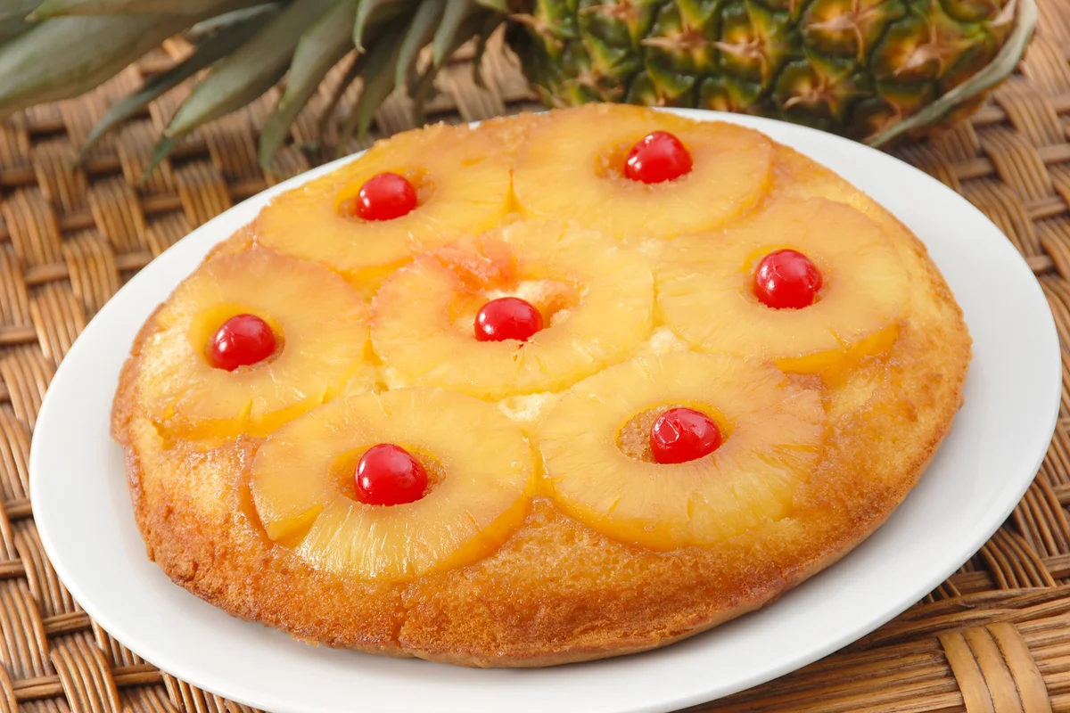 Pineapple upside down cake garnished with maraschino cherries
