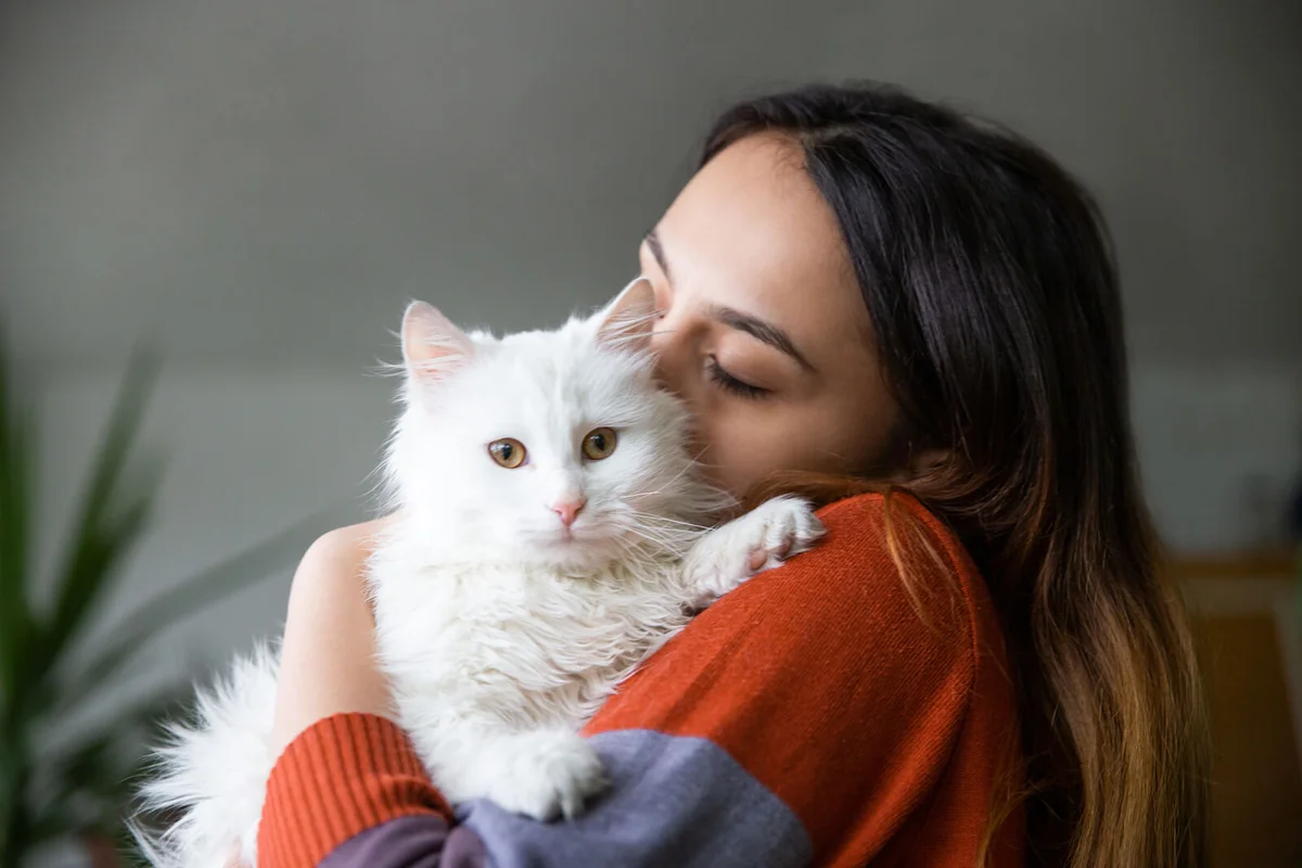 Young woman with her pet cat