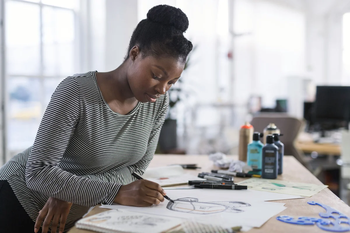 illustrator creating art at drawing table