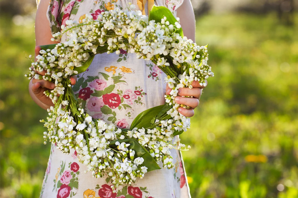 girl holding spring flower wreath