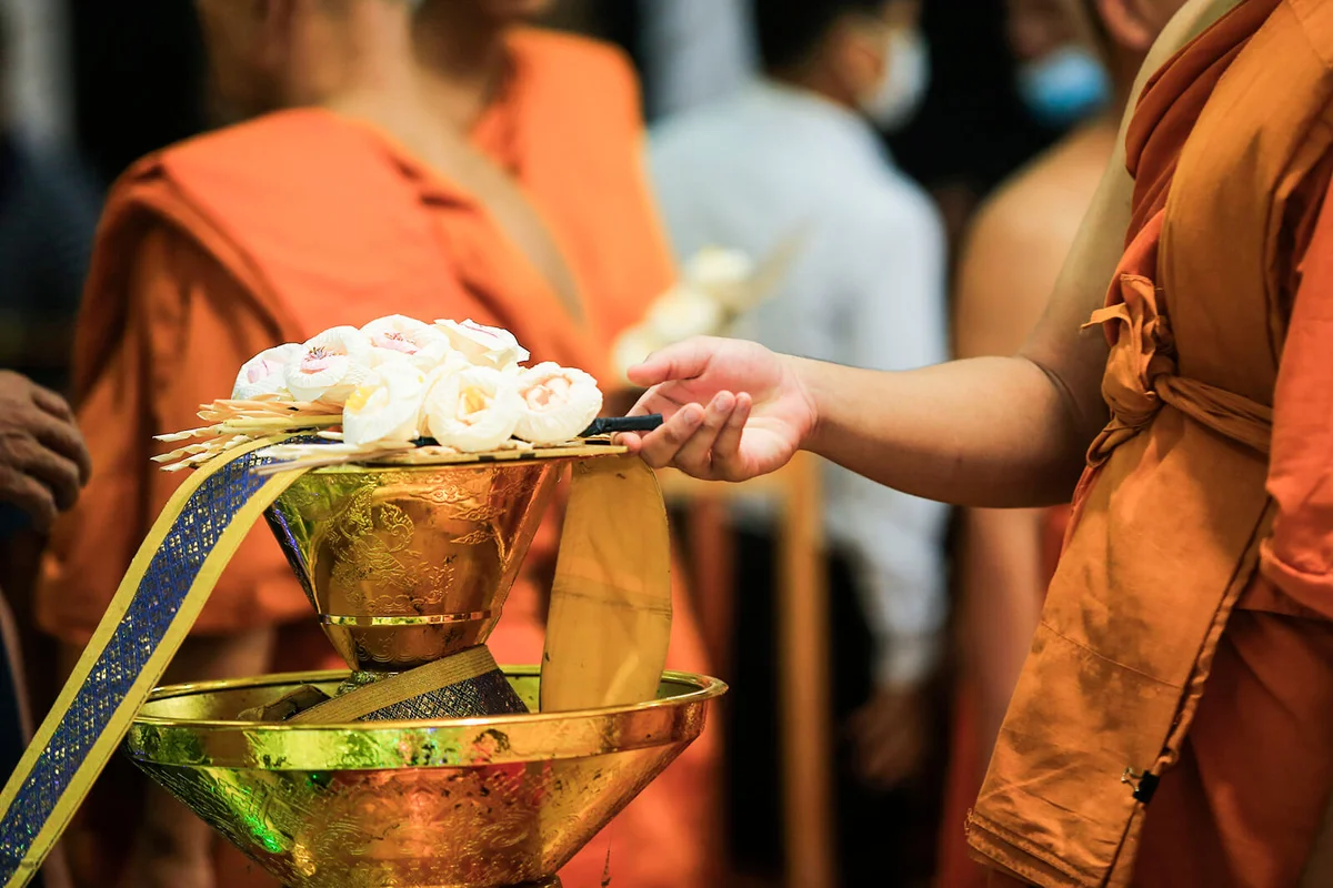 Monk Placing A Cremation Flower On The Tray To Pray For Dead People