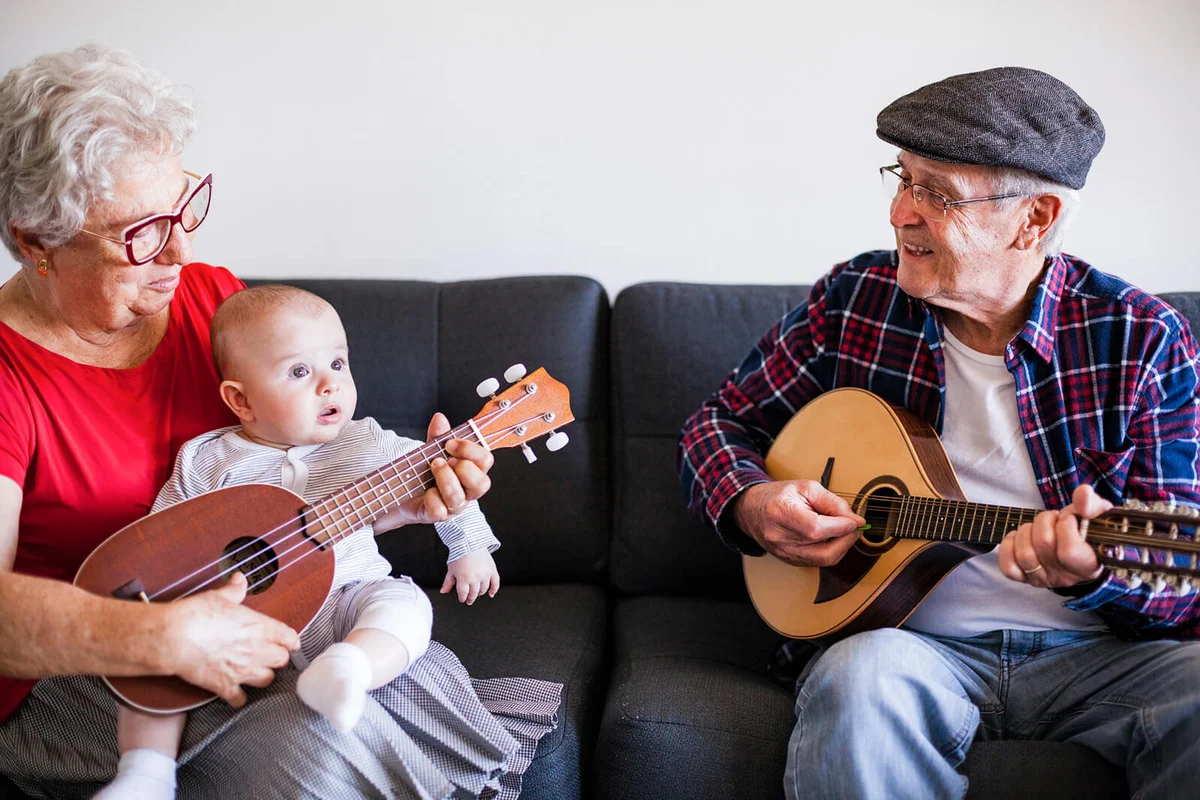 Senior couple playing music for baby