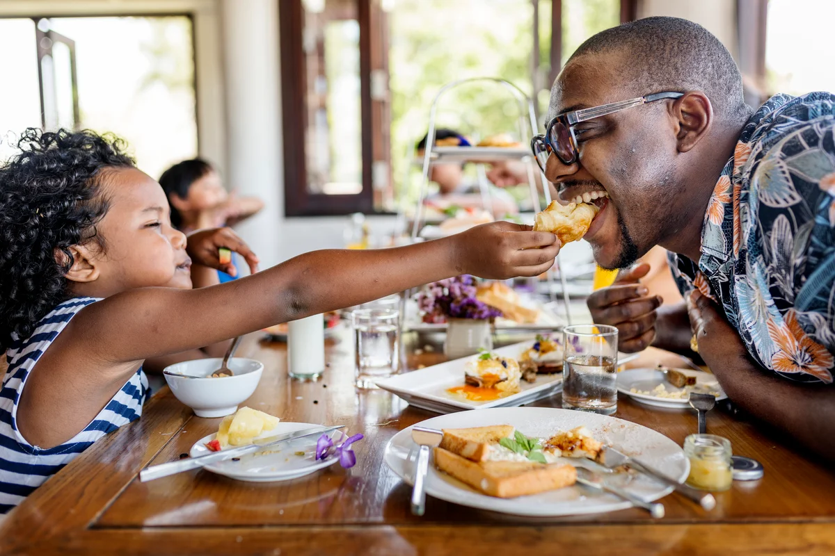 family vacation eating meal at restaurant