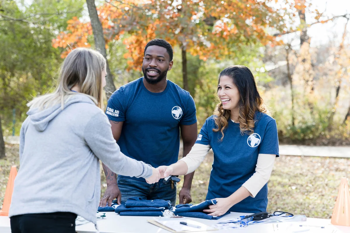 Friendly volunteer greets woman during charity event
