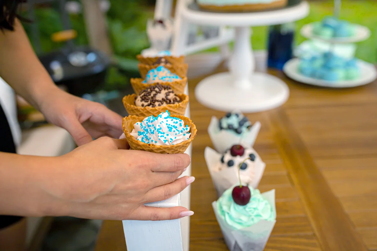 Girl serving ice cream cones with different flavors
