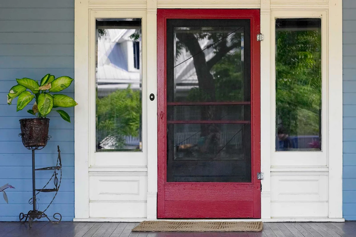 vintage plant stand at front door