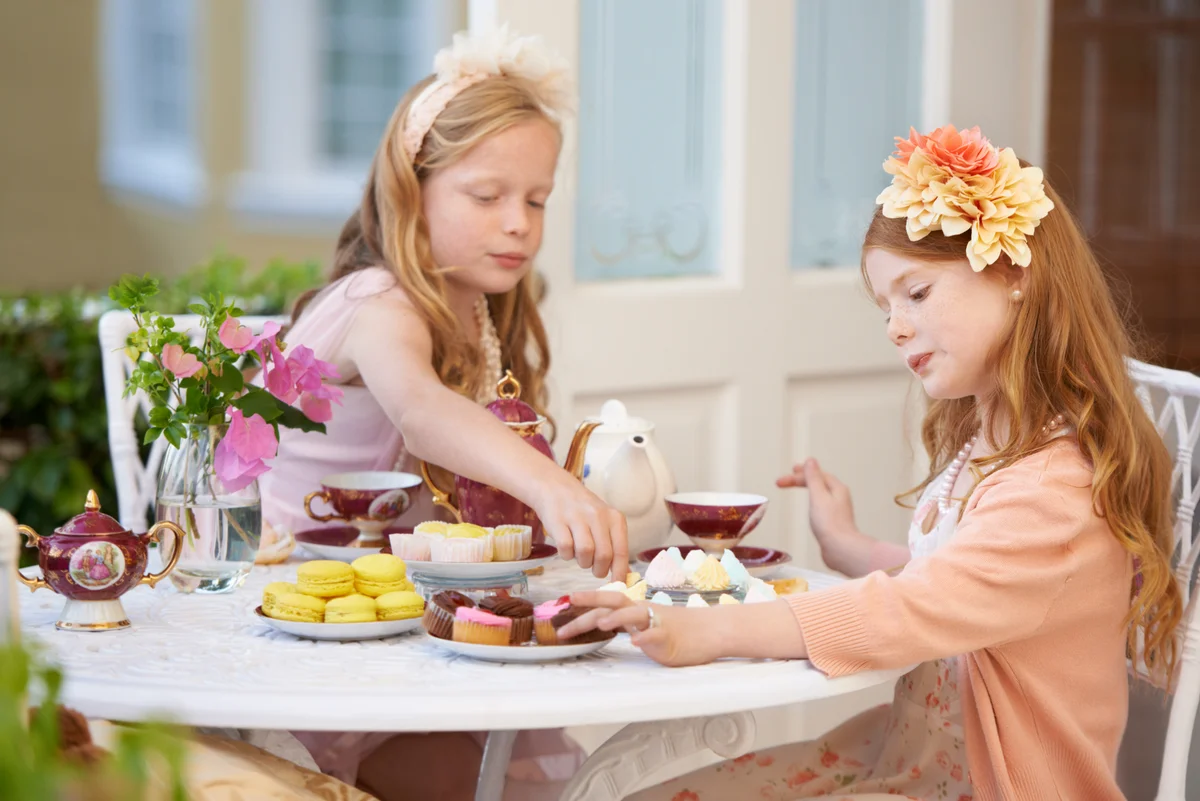 two girls having a garden tea party