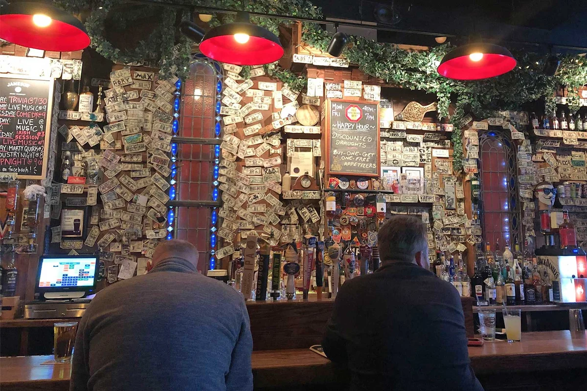 dive bar with dollar bills on wall