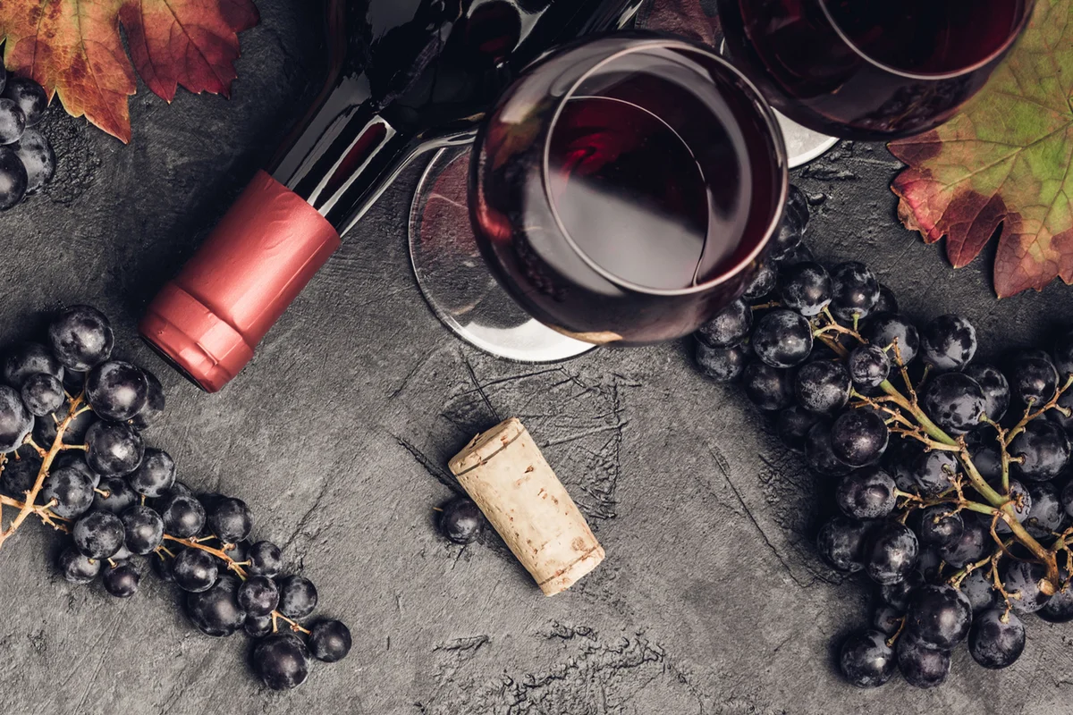 Wine with grapes, leaves and corks