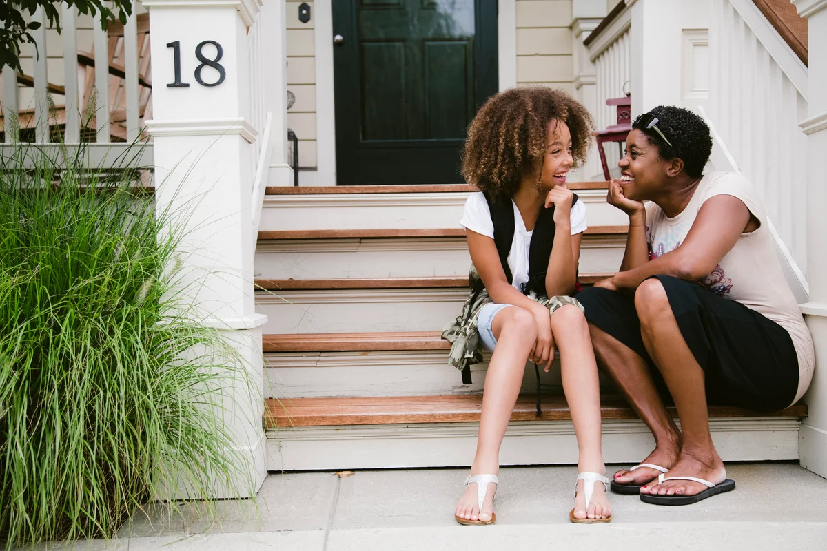 mother and daughter happy on front porch address 18