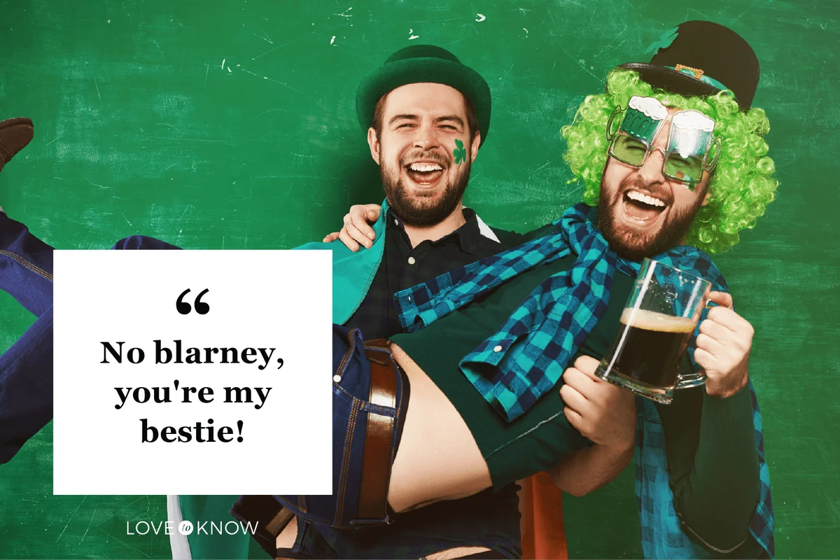 Cheerful man holding friend in his arms at St Patricks Day party