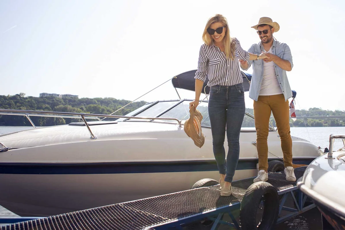 couple on dock by speedboat