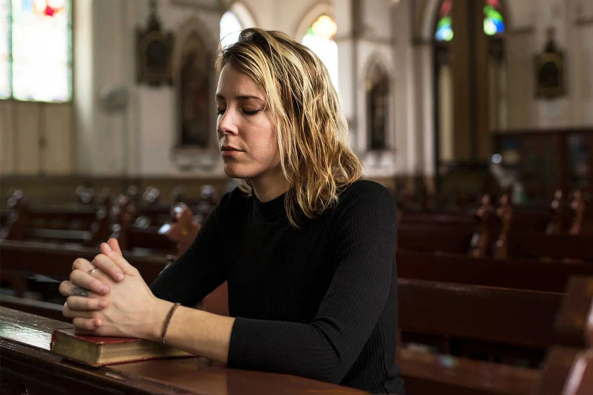 mother kneel pray at church