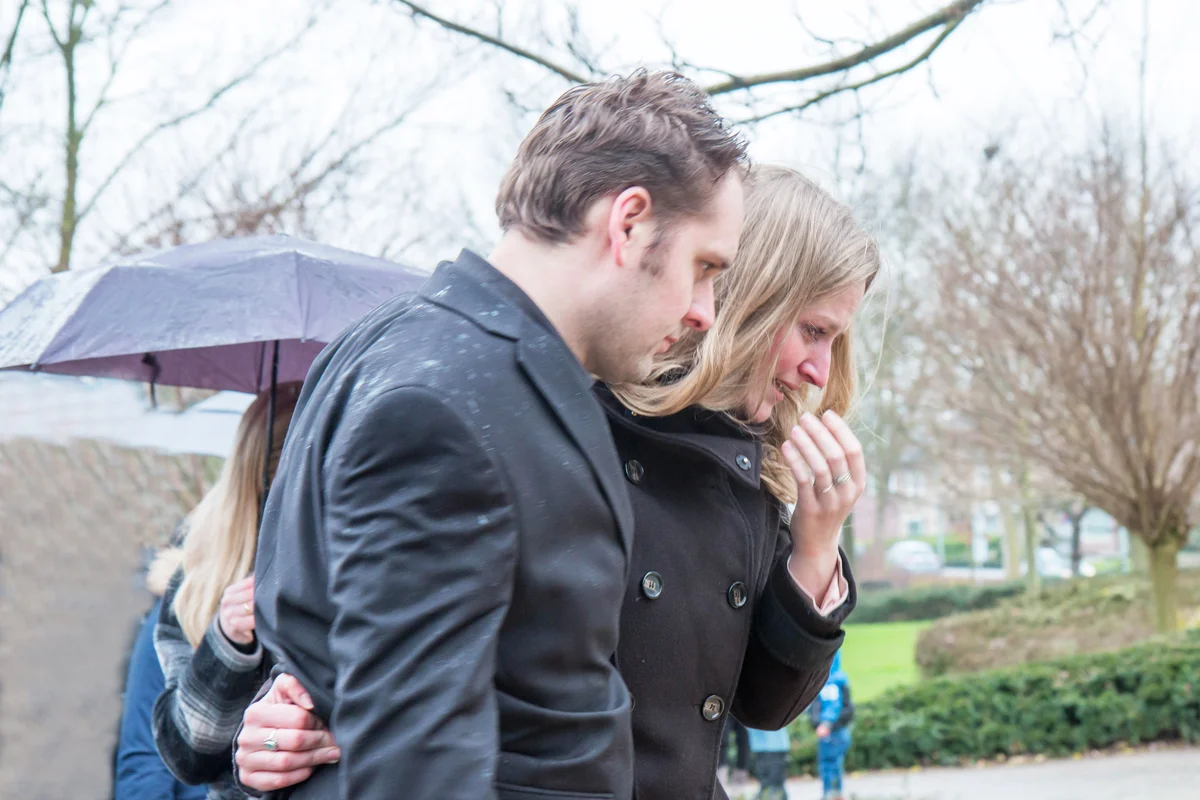 grieving parents at funeral