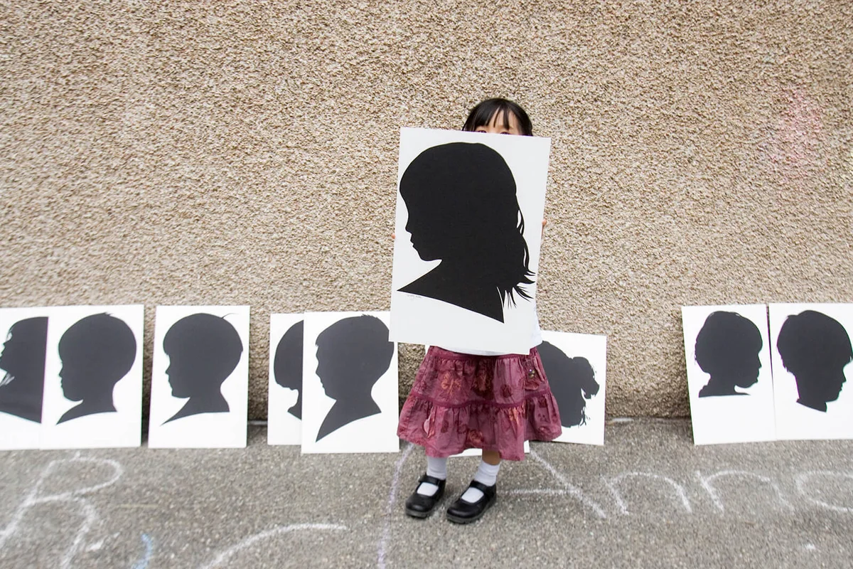 Preschooler holds silhouette