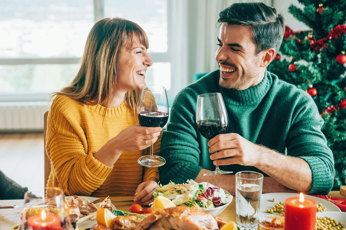 Happy couple drinking wine on Christmas