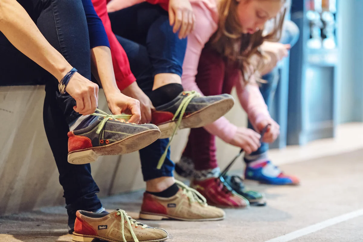 Girls at the bowling putting on shoes