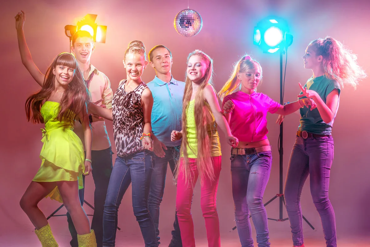 Group of young people having fun and dancing at a holiday party