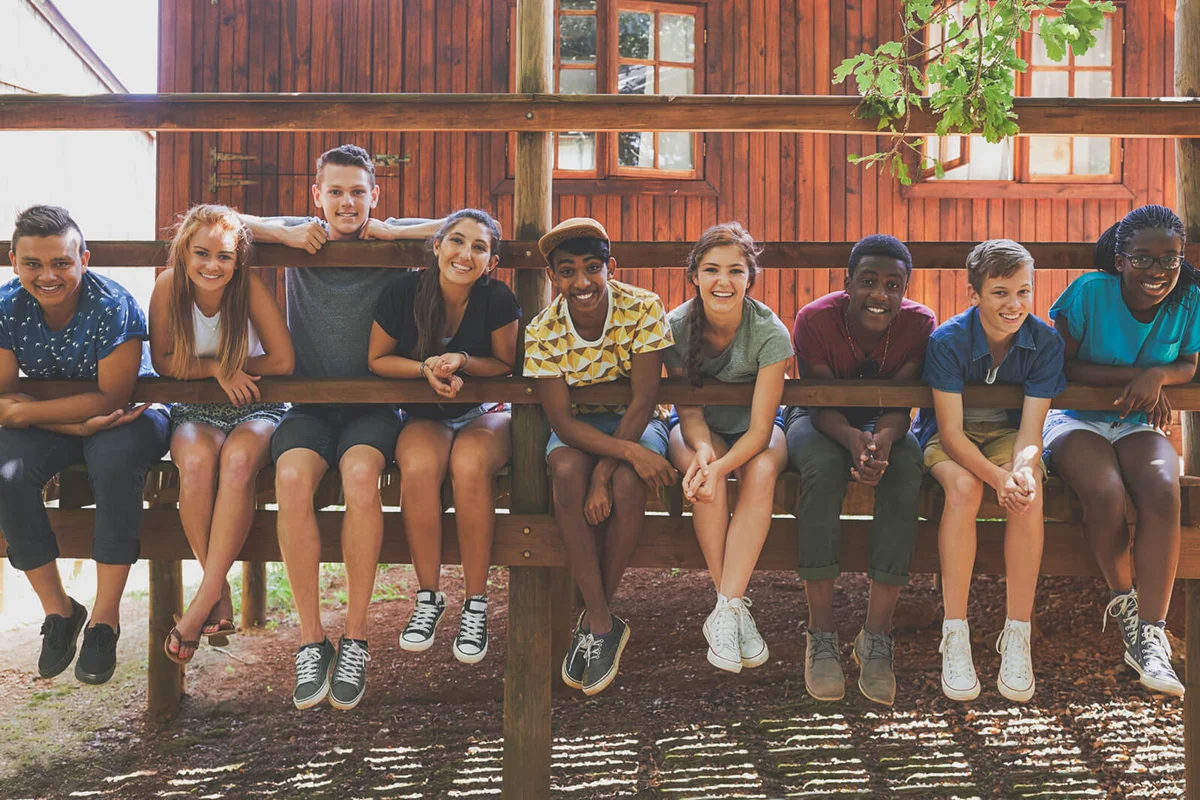 Shot of a group of friends sitting together outside
