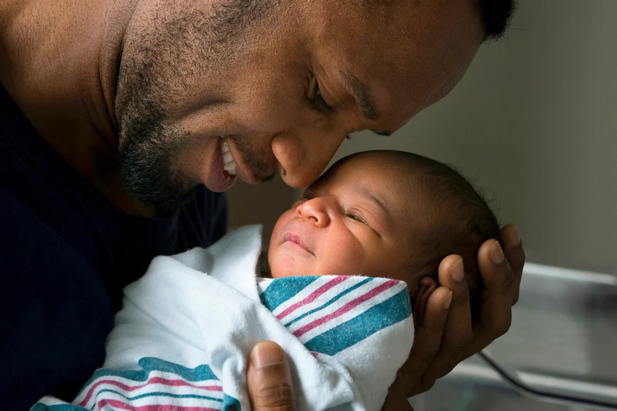 Father admiring newborn son
