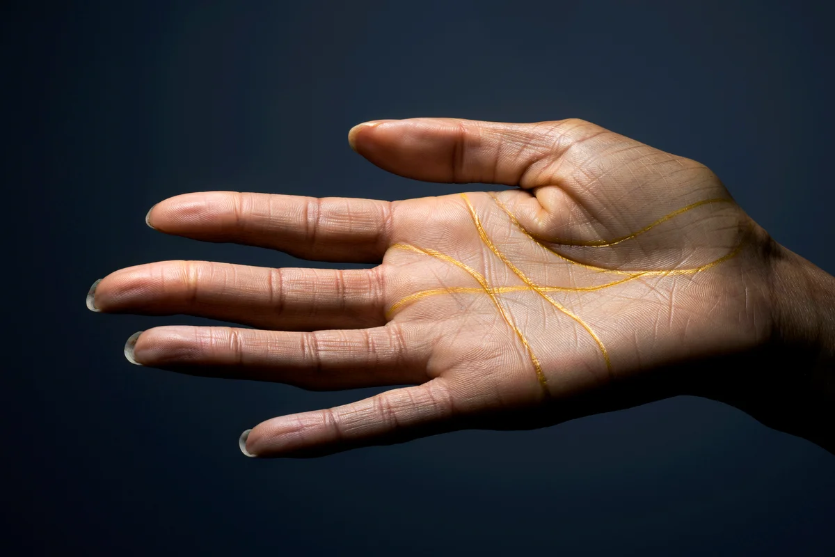 Hand covered with gold lines