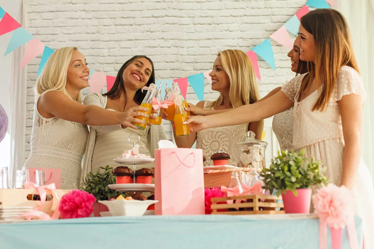 women at baby shower toasting with drinks