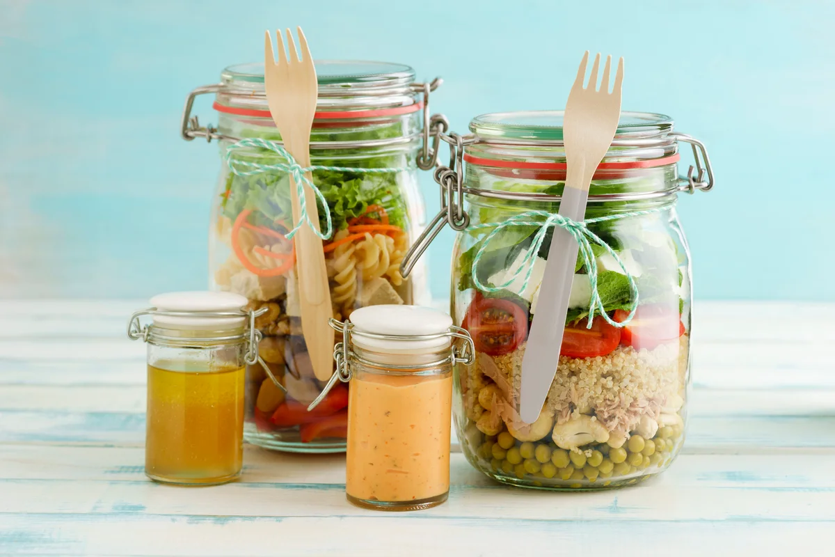 Preserving jars of mixed salads and jars of dressings