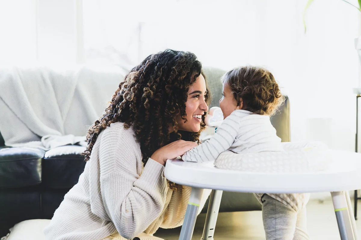 Au pair and baby look into each other's eyes