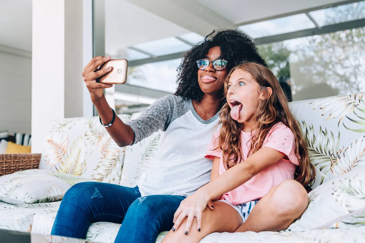 Two young friends making funny faces while taking a selfie