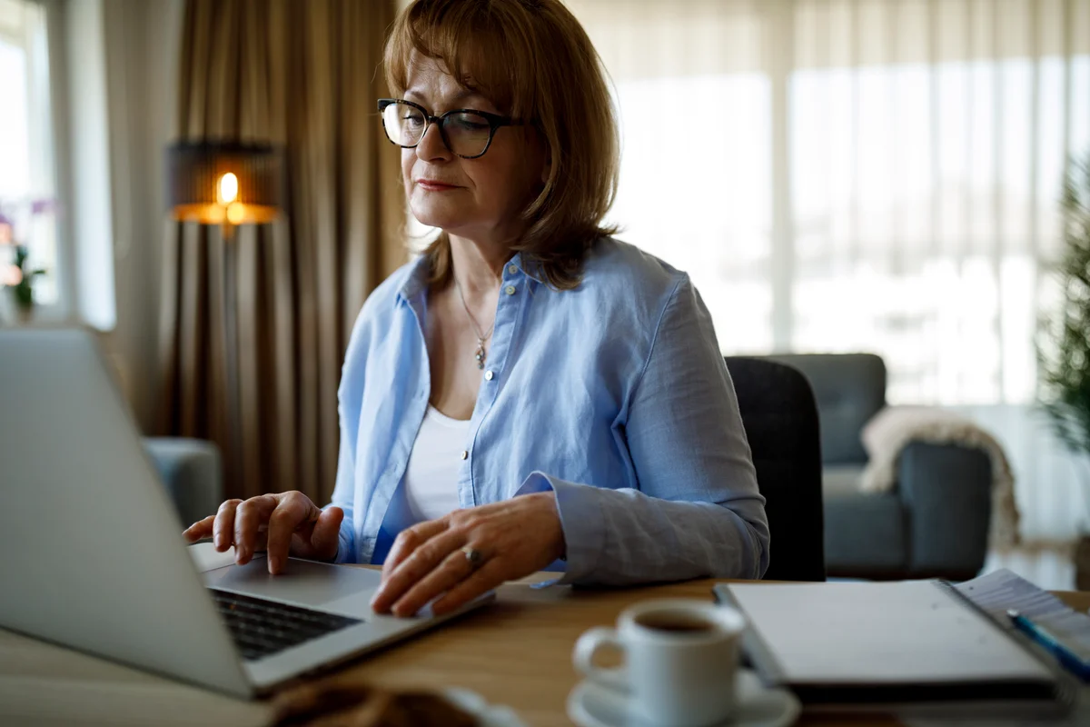 senior woman on laptop checking for social security payment
