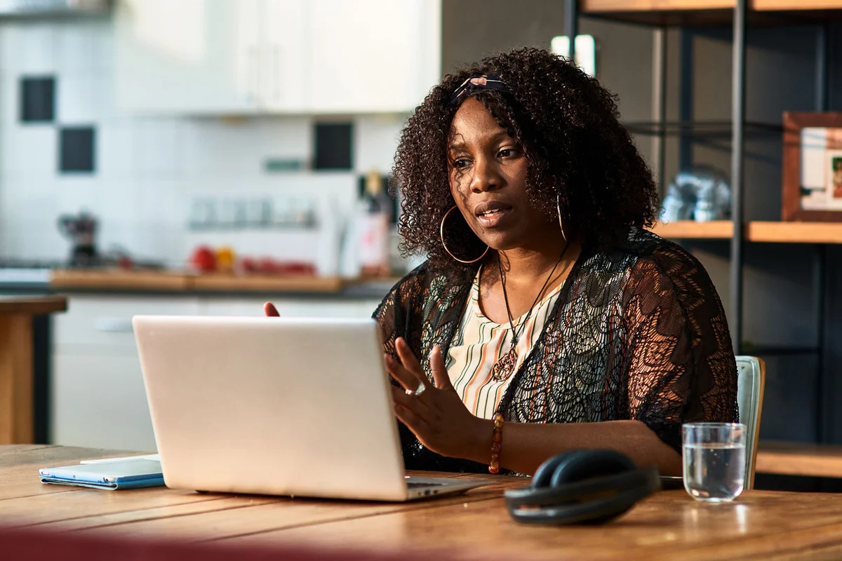 woman at home with online grief support group
