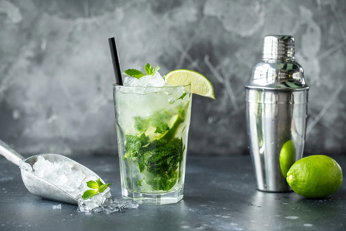 Mojito with lime, mint, ice. Drink bar tools shaker and ingredients