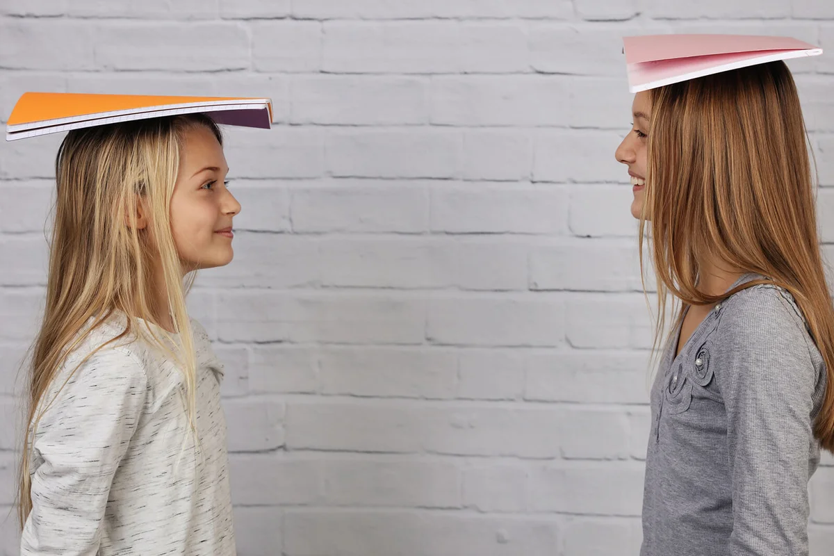 School girls with books on head