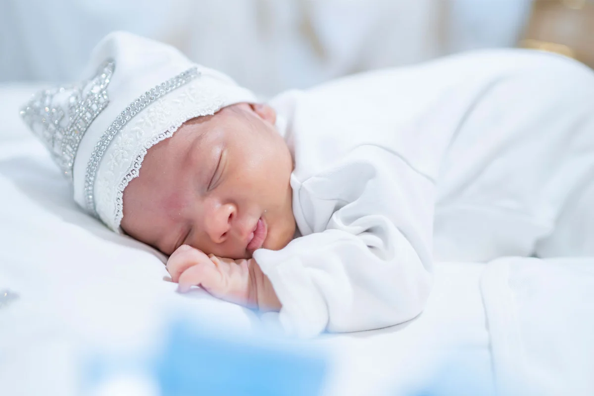 infant boy with short name sleeping in bassinet