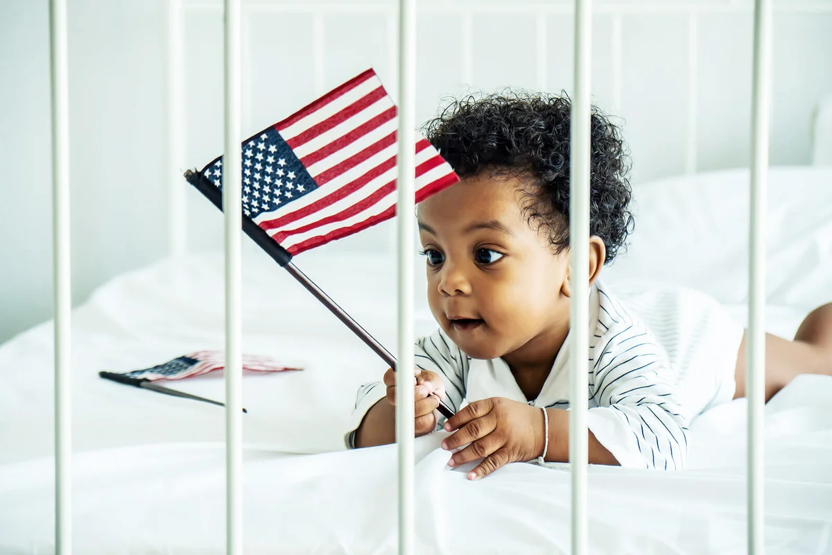 Cute Kid Holding American Flag Playing At Home