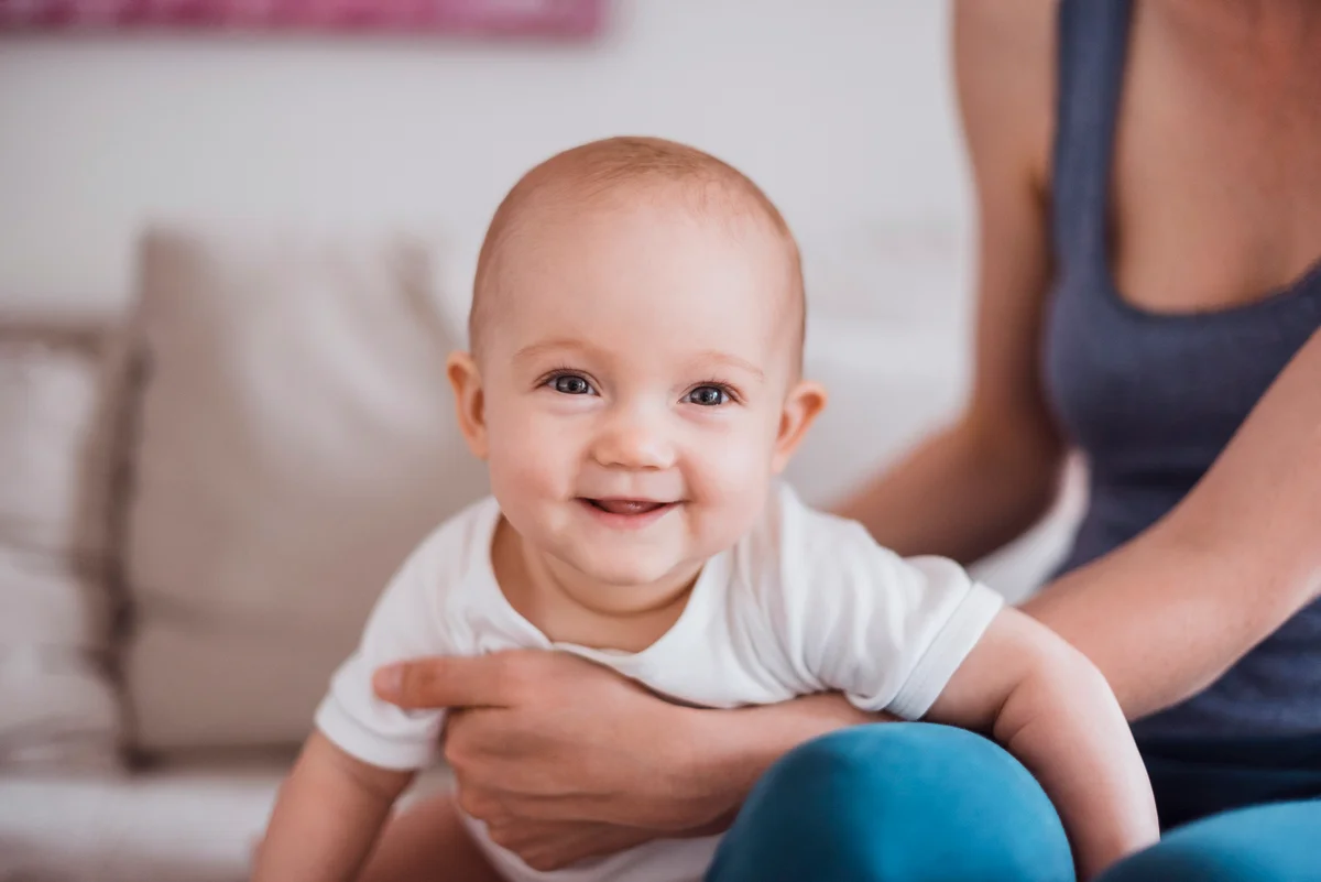 Baby girl with mother at home