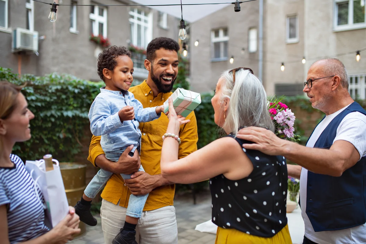 godparents giving gift to godson at party