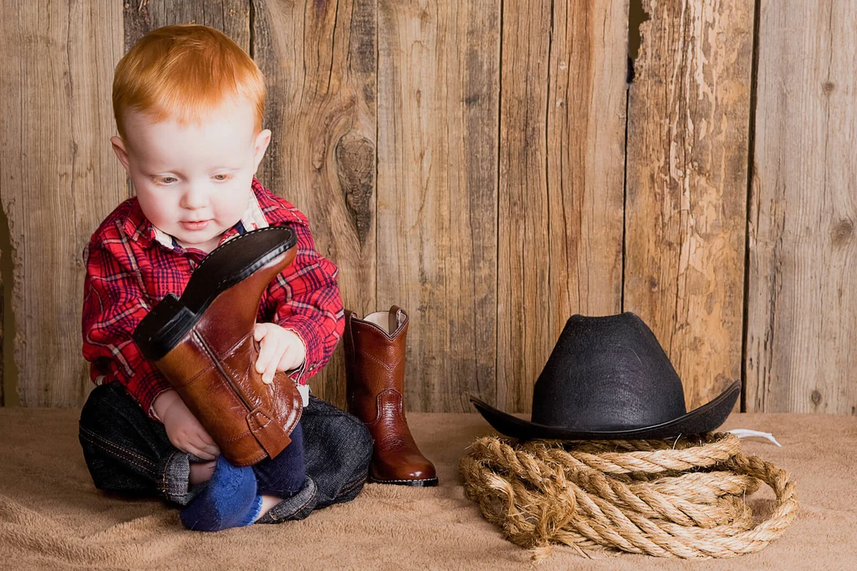 A young toddler boy in western wear