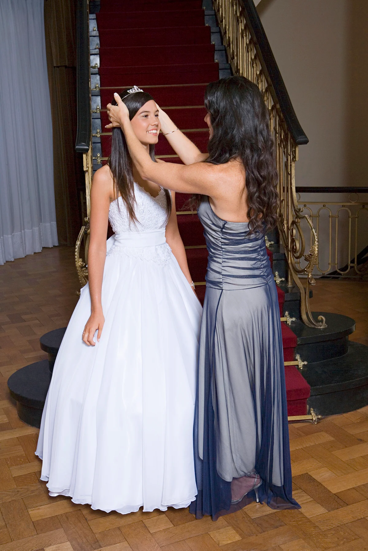Mother placing tiara on daughters head