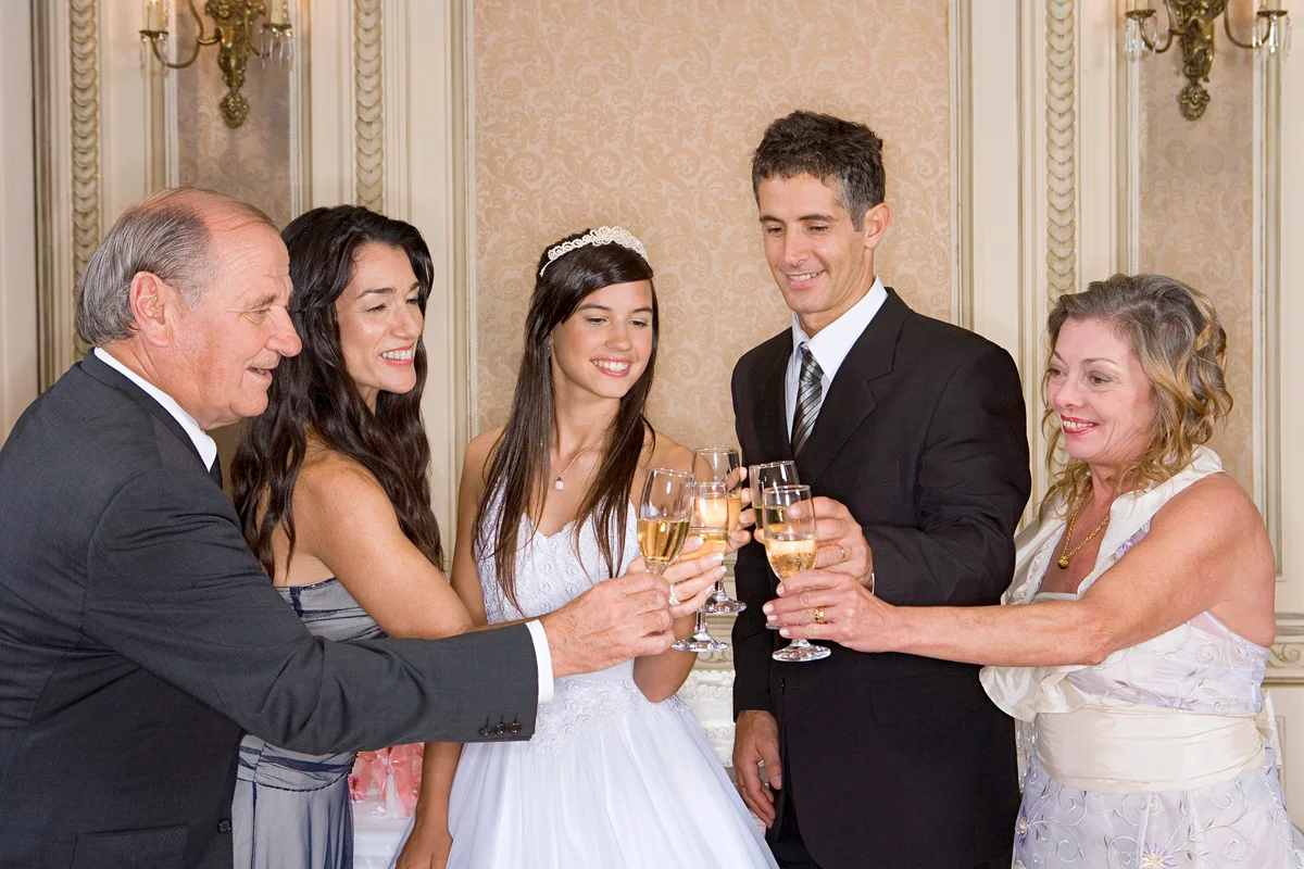 Quinceanera girl toasting with family