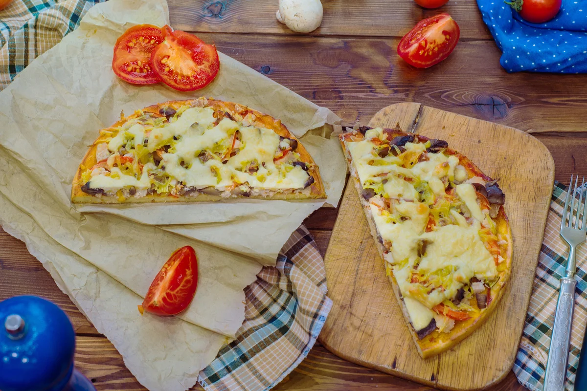 pieces of pizza on a cutting board, top view