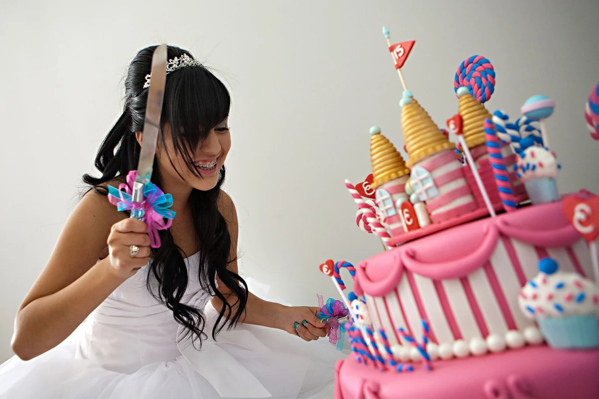 quinceanera party cutting cake