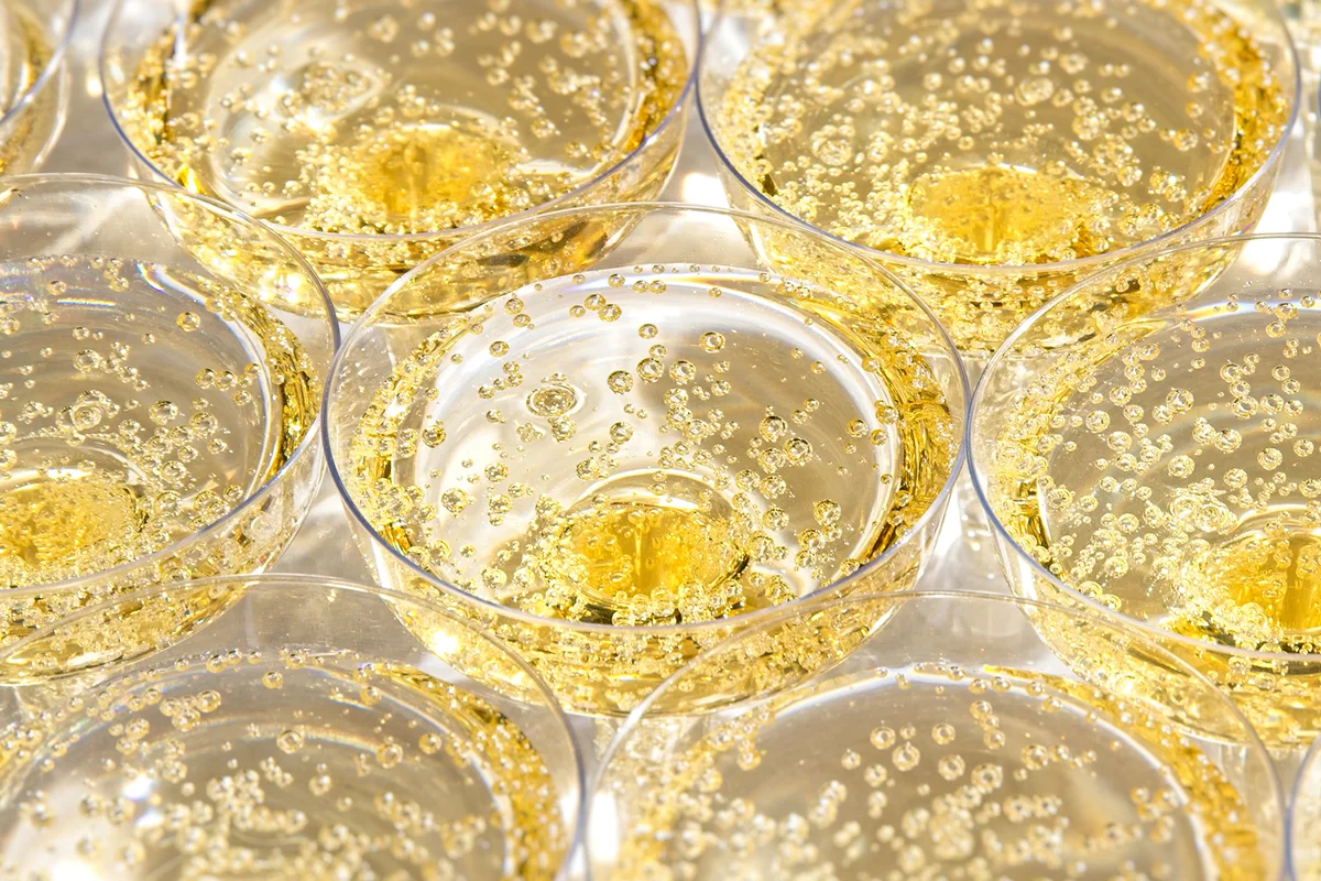 Zoom of glasses with bubbling champagne