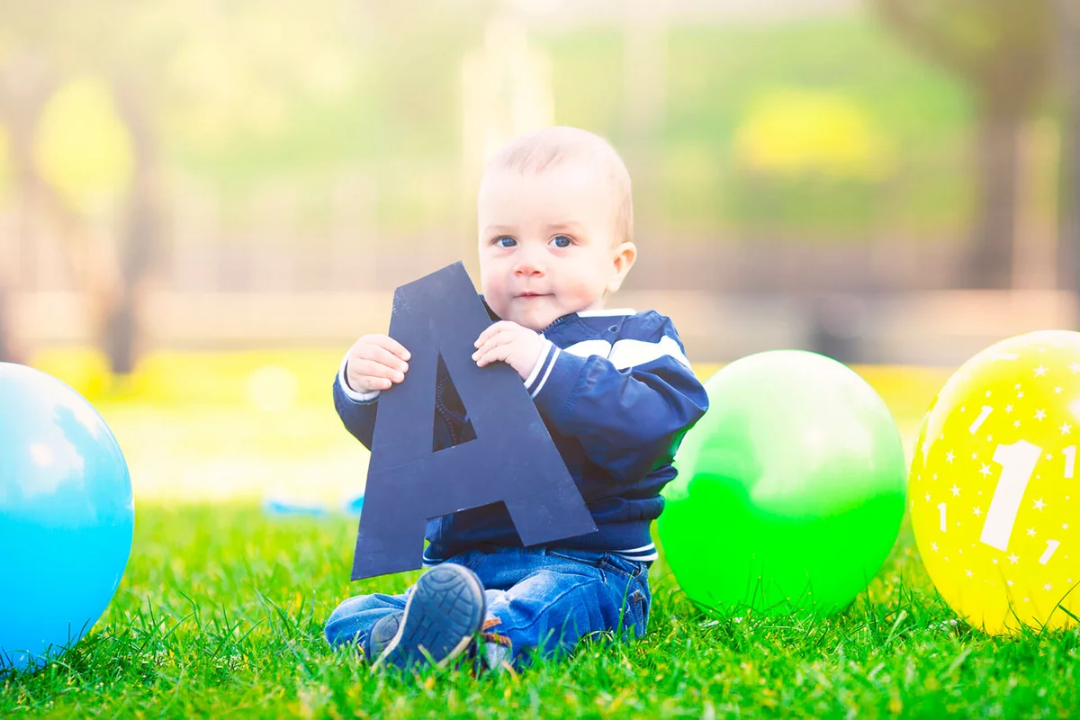 Baby boy holding letter A