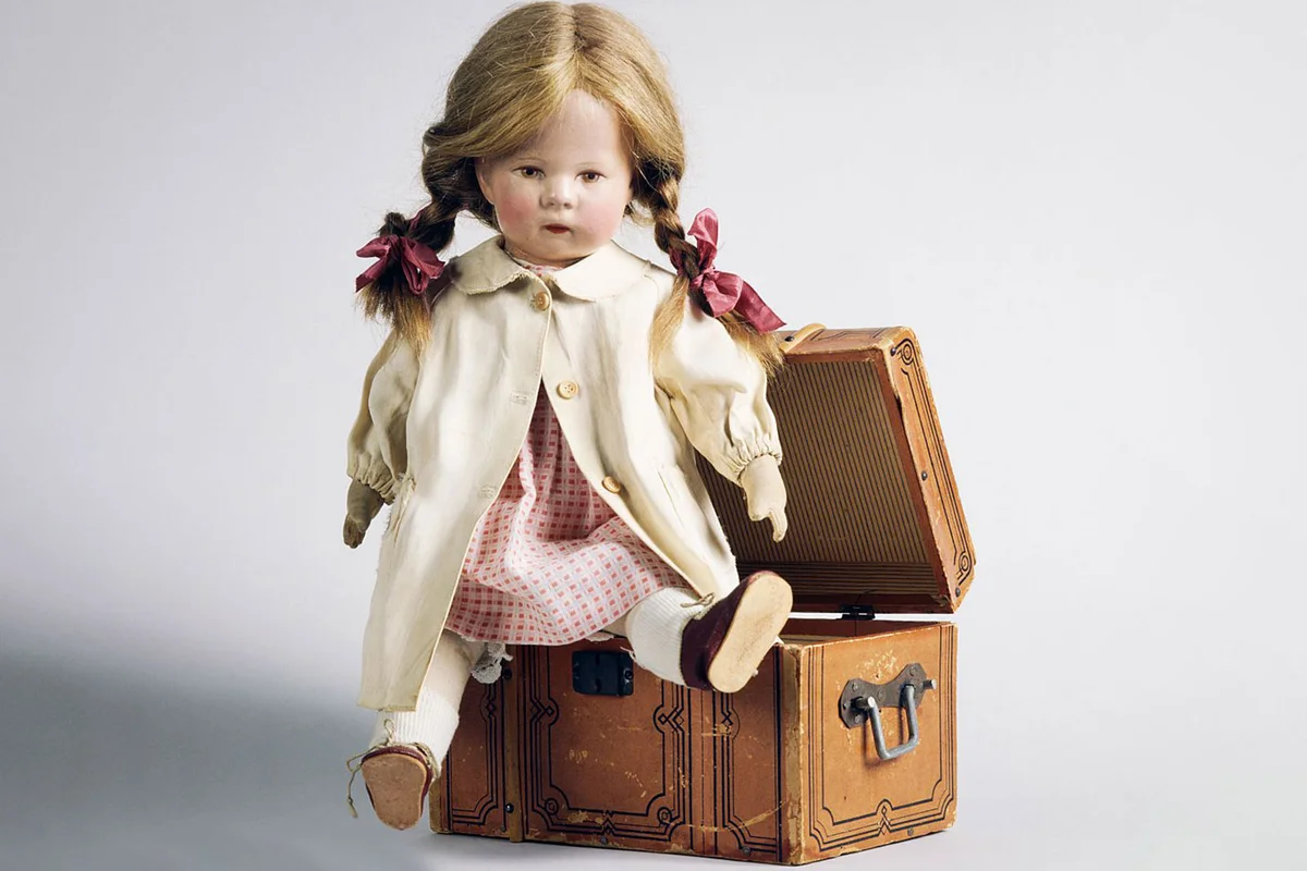 doll on vintage toy steamer trunk
