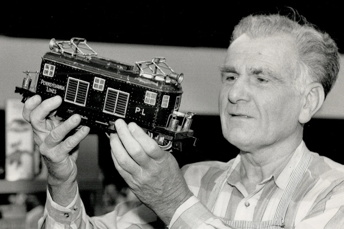 George Olieux of George's Trains Ltd. shows off a model train car - Getty Editorial Use