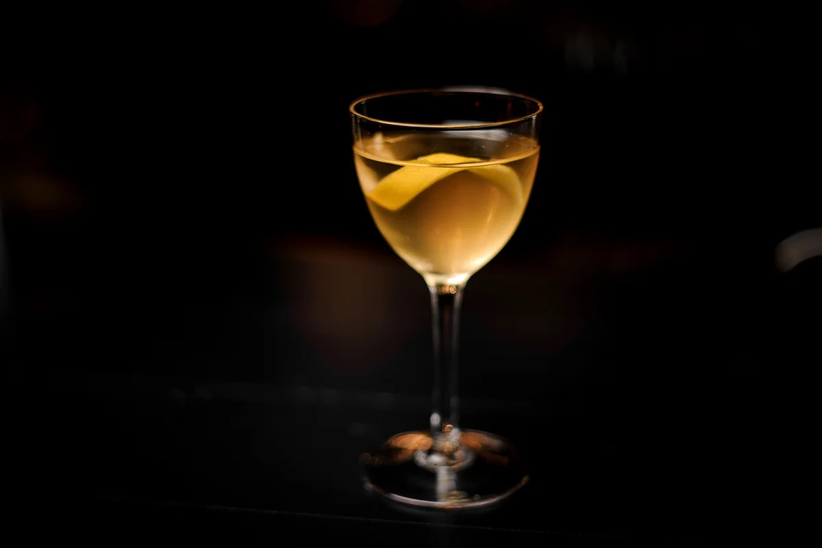 Alaska cocktail in the glass decorated with a lemon zest