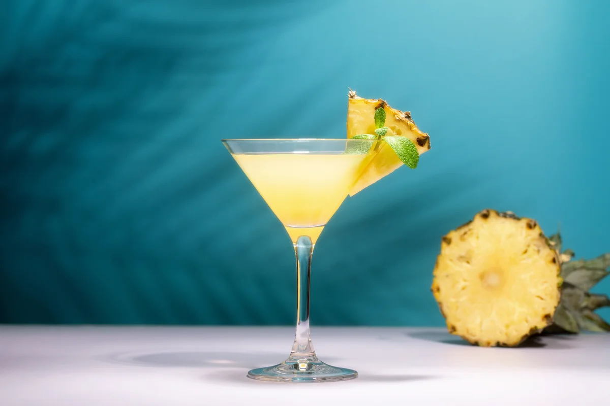 Pineapple cocktail with slice of pineapple and mint