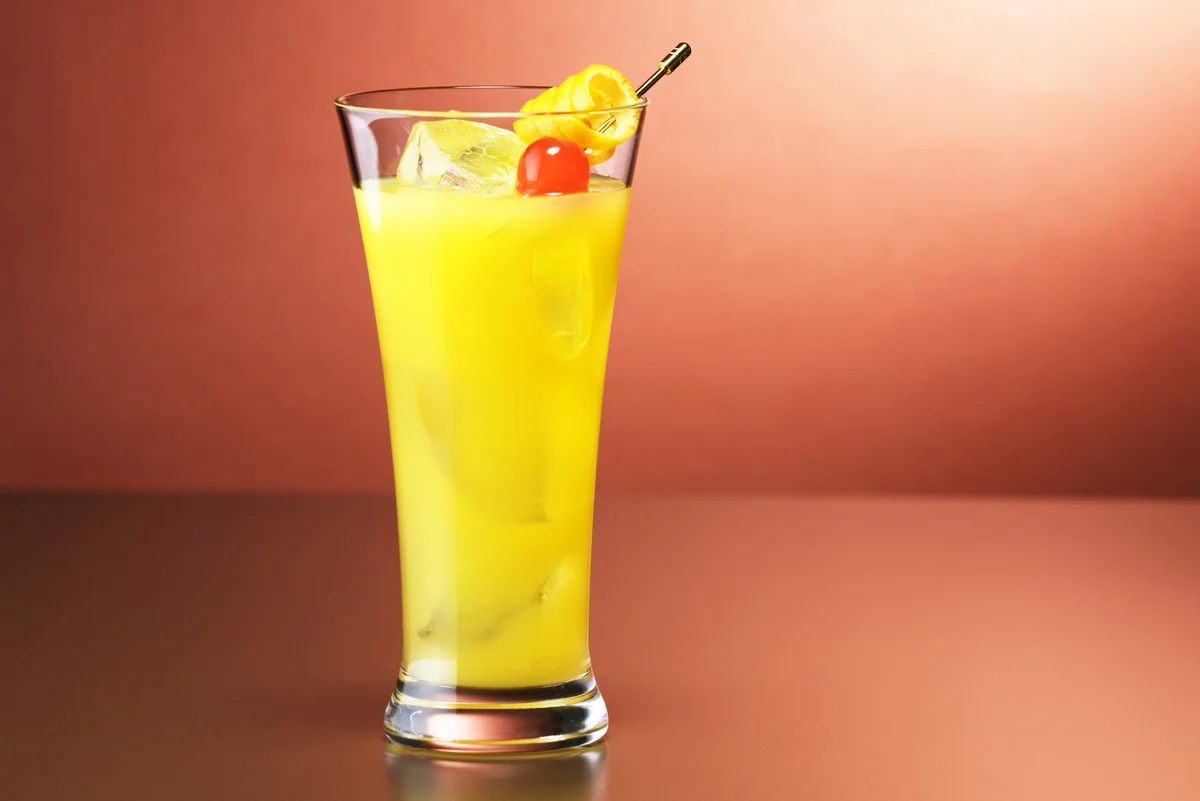 Yellow hammer cocktail on red background